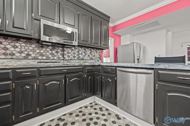 130 Kingswood Dr, Huntsville, AL 35806 - kitchen with light countertops, crown molding, visible vents, decorative backsplash, and appliances with stainless steel finishes