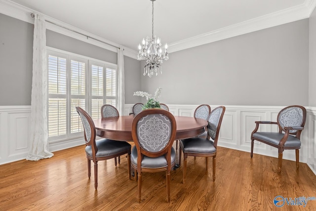 130 Kingswood Dr, Huntsville, AL 35806 - dining space featuring an inviting chandelier, ornamental molding, a wainscoted wall, and wood finished floors