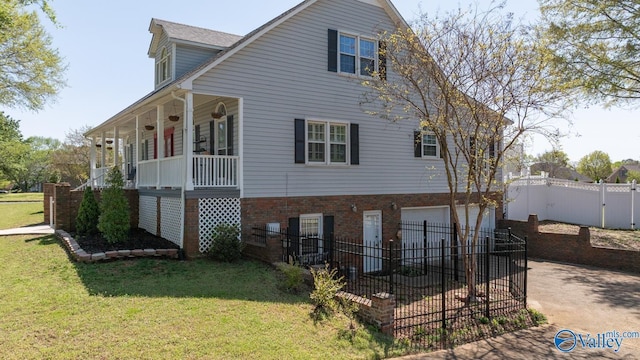 130 Kingswood Dr, Huntsville, AL 35806 - rear view of house with concrete driveway, a garage, fence, a lawn, and covered porch