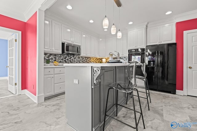 130 Kingswood Dr, Huntsville, AL 35806 - kitchen with stainless steel microwave, crown molding, black fridge with ice dispenser, white cabinets, and decorative backsplash