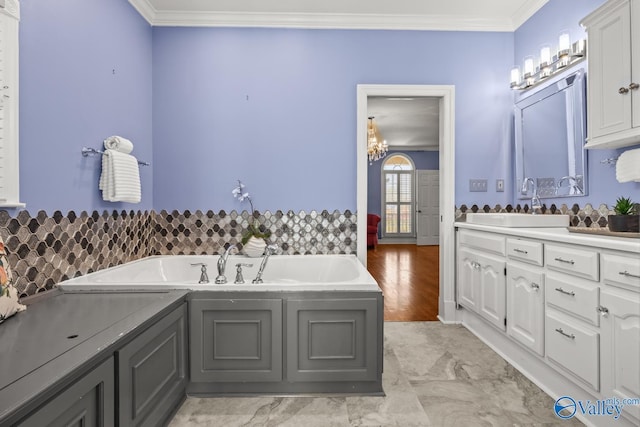 130 Kingswood Dr, Huntsville, AL 35806 - bathroom featuring a chandelier, a bath, vanity, and ornamental molding