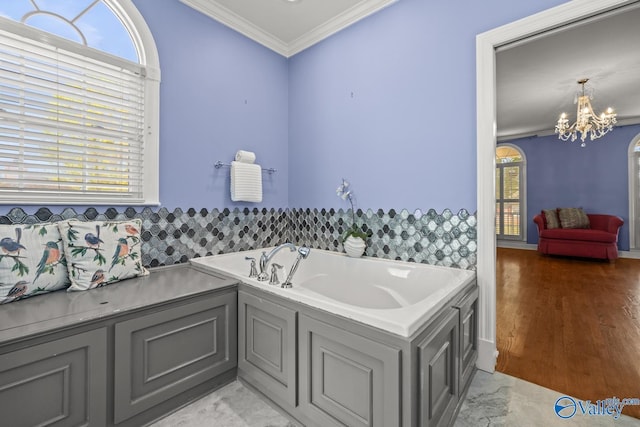 130 Kingswood Dr, Huntsville, AL 35806 - full bathroom featuring plenty of natural light, a notable chandelier, crown molding, and a garden tub