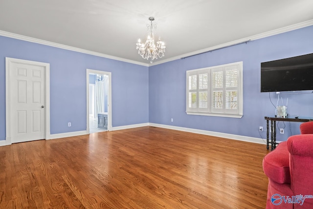 130 Kingswood Dr, Huntsville, AL 35806 - living room featuring baseboards, an inviting chandelier, crown molding, and wood finished floors