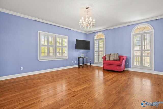 130 Kingswood Dr, Huntsville, AL 35806 - living area featuring a chandelier, crown molding, and a healthy amount of sunlight