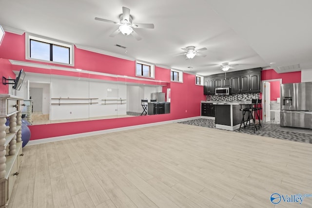 130 Kingswood Dr, Huntsville, AL 35806 - interior space featuring a ceiling fan, visible vents, appliances with stainless steel finishes, open floor plan, and backsplash