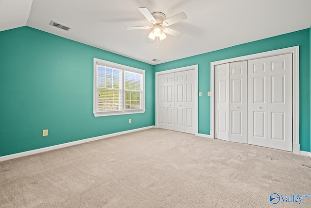 130 Kingswood Dr, Huntsville, AL 35806 - unfurnished bedroom featuring baseboards, carpet floors, visible vents, multiple closets, and lofted ceiling