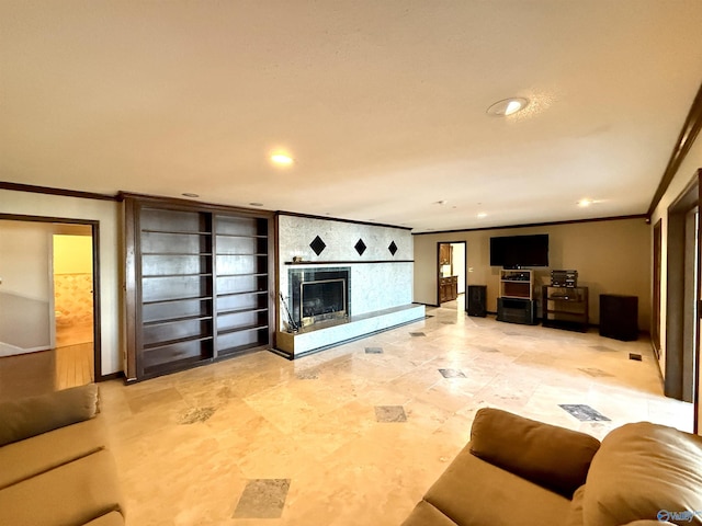 living room with built in shelves, crown molding, and a fireplace