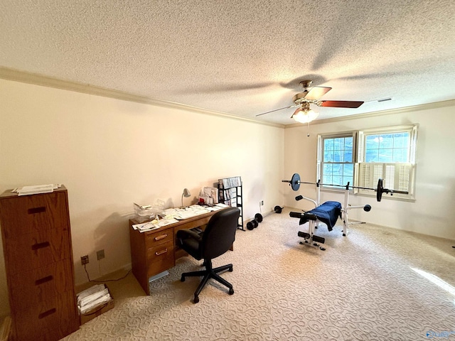 carpeted office space featuring ceiling fan, a textured ceiling, and ornamental molding