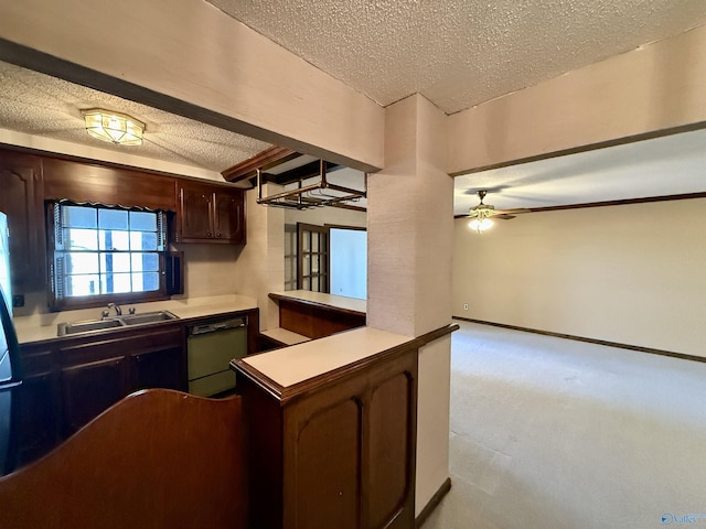 kitchen featuring ceiling fan, dishwasher, sink, dark brown cabinetry, and a textured ceiling