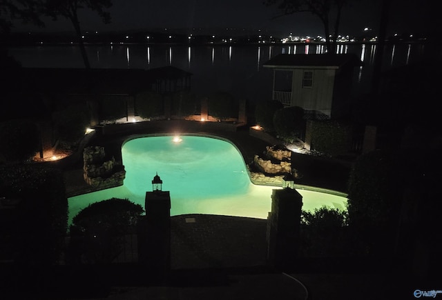 view of pool at night