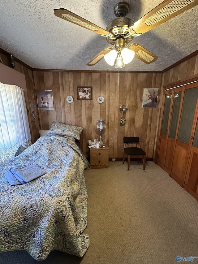 bedroom featuring a textured ceiling, carpet floors, ornamental molding, and wooden walls