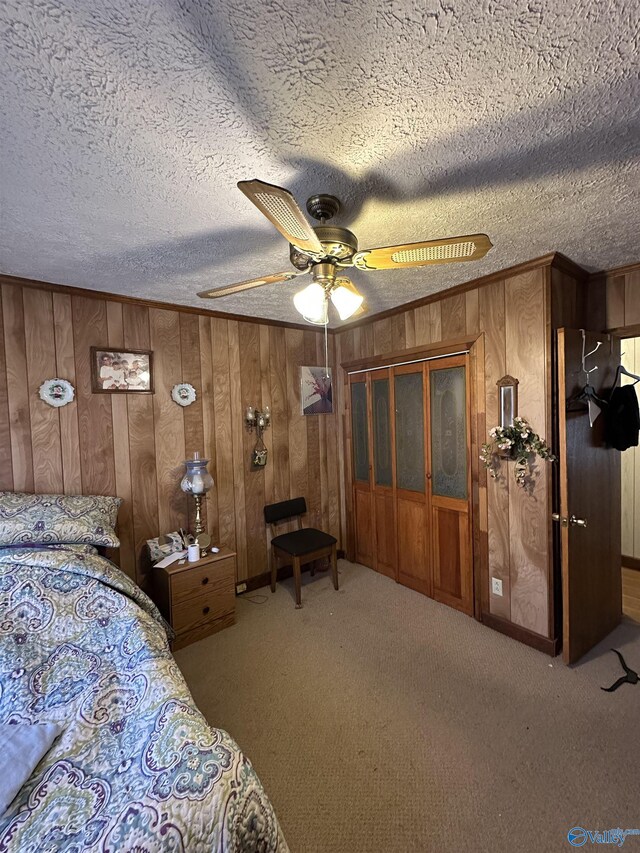 bedroom featuring carpet, wood walls, crown molding, and a textured ceiling