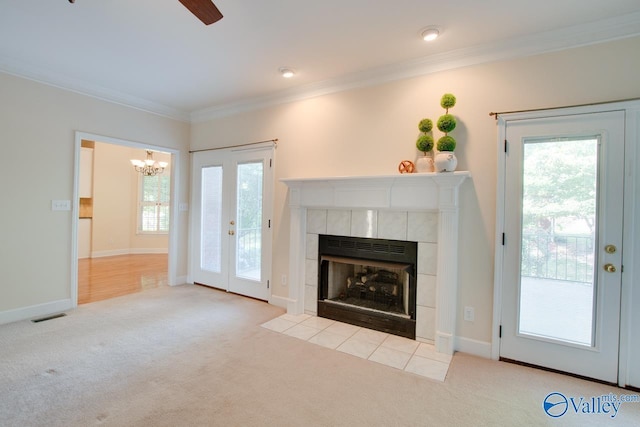 102 Twin Island Cir, Madison, AL 35758 - unfurnished living room featuring carpet, a tiled fireplace, ornamental molding, a chandelier, and ceiling fan