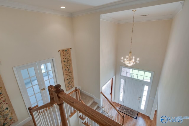 102 Twin Island Cir, Madison, AL 35758 - entryway with a high ceiling, a chandelier, healthy amount of natural light, crown molding, and baseboards