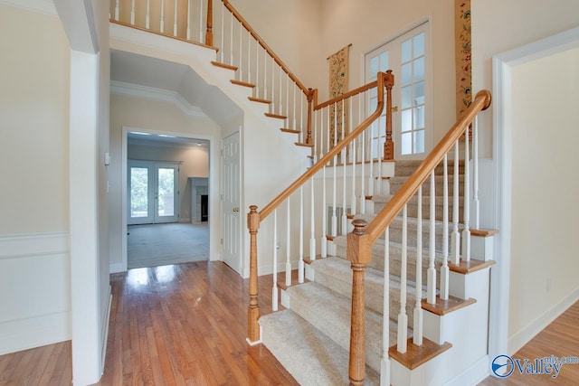 102 Twin Island Cir, Madison, AL 35758 - stairs featuring wood finished floors, french doors, ornamental molding, a high ceiling, and baseboards