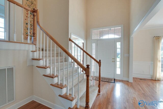 102 Twin Island Cir, Madison, AL 35758 - entryway featuring a high ceiling, healthy amount of natural light, wood finished floors, and stairs