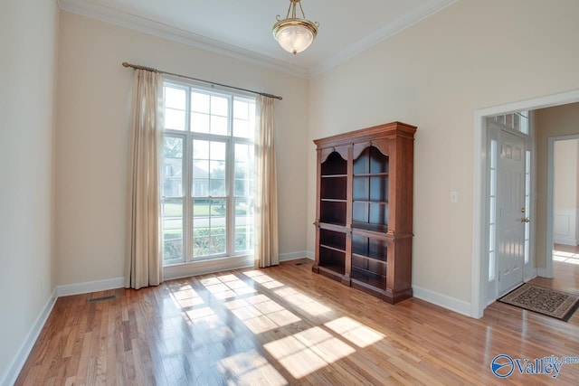 102 Twin Island Cir, Madison, AL 35758 - spare room with healthy amount of natural light, wood finished floors, crown molding, and baseboards