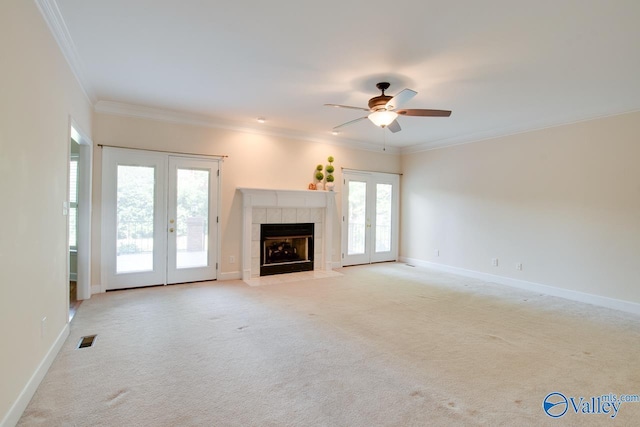 102 Twin Island Cir, Madison, AL 35758 - unfurnished living room with french doors, ornamental molding, light carpet, a fireplace, and ceiling fan