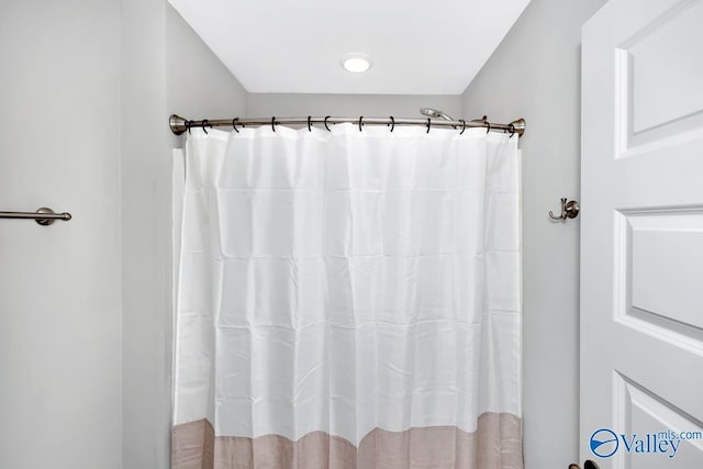 bathroom with a shower with curtain