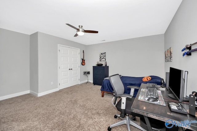 office area with carpet, baseboards, and ceiling fan