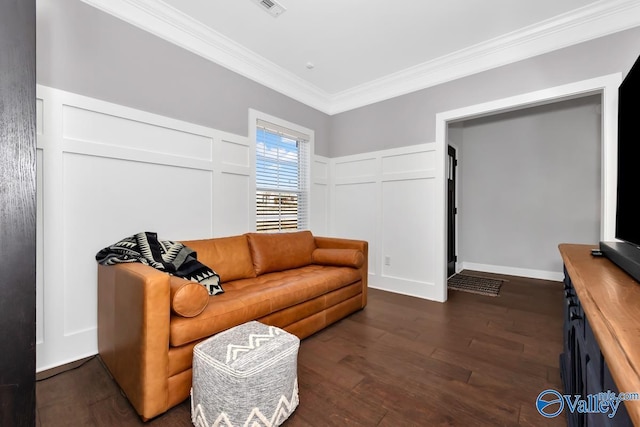 living room featuring dark wood-style floors, ornamental molding, a wainscoted wall, and a decorative wall