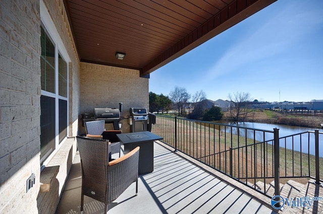 balcony featuring area for grilling and a water view