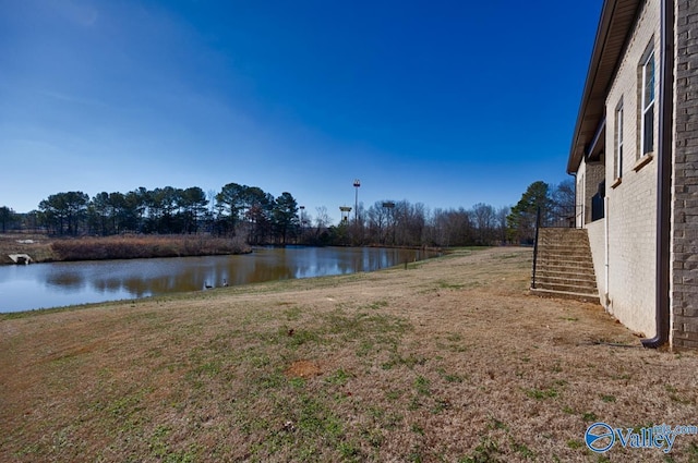 view of yard with a water view and stairway