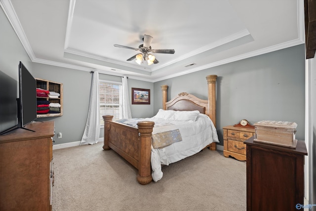 bedroom with visible vents, ornamental molding, ceiling fan, light colored carpet, and a raised ceiling