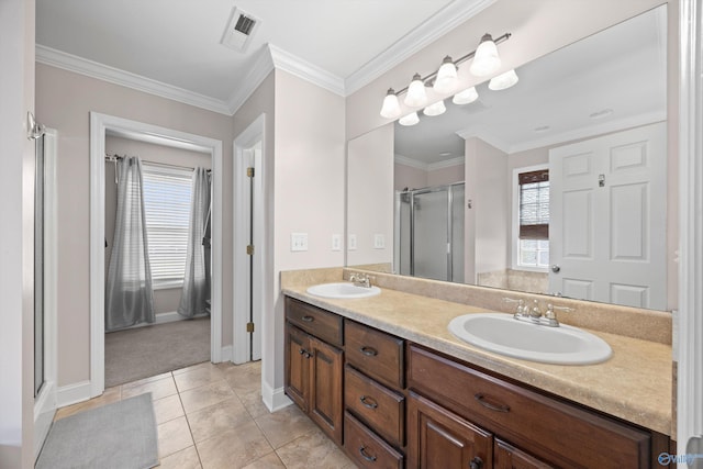 bathroom featuring a sink, a stall shower, double vanity, and visible vents