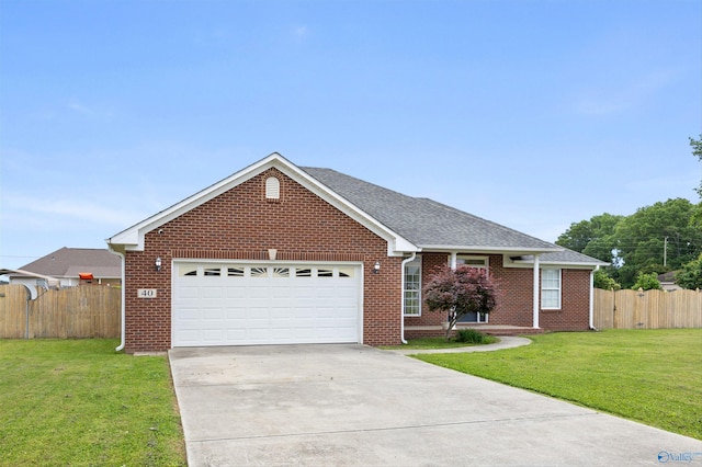 ranch-style house featuring an attached garage, fence, driveway, and a front yard