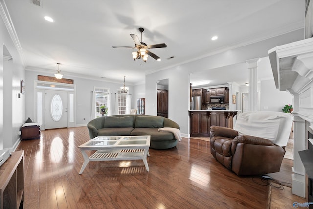 living area with visible vents, a fireplace, recessed lighting, hardwood / wood-style flooring, and ceiling fan with notable chandelier