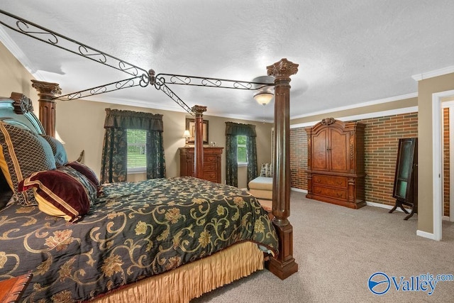 bedroom featuring a textured ceiling, brick wall, ceiling fan, crown molding, and light colored carpet