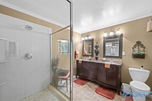 full bathroom with double vanity, toilet, a stall shower, crown molding, and a textured ceiling