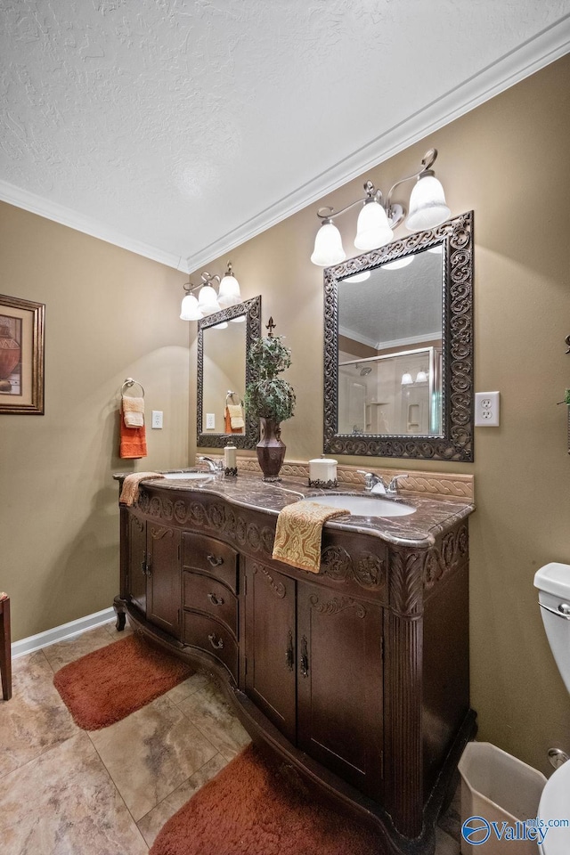 bathroom with double vanity, toilet, crown molding, a textured ceiling, and a shower