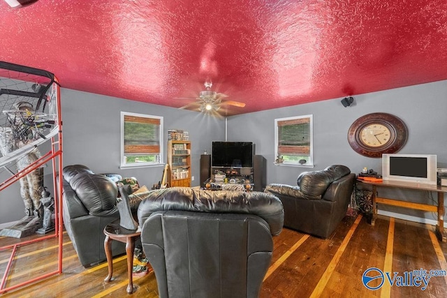 living area featuring ceiling fan, a textured ceiling, and wood-type flooring