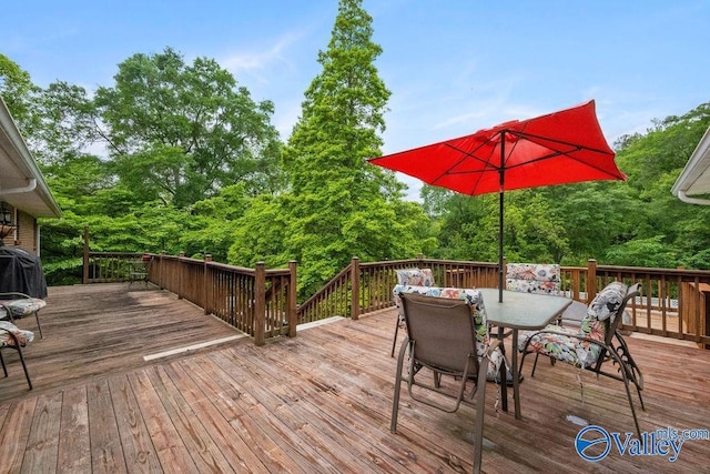 wooden terrace with outdoor dining area