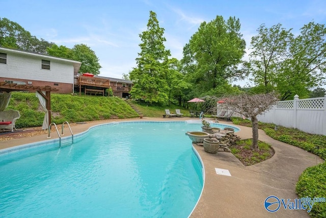 view of swimming pool featuring a patio area, a fenced in pool, and fence