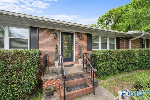 property entrance with brick siding