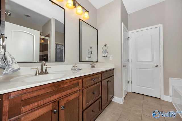 full bathroom with a stall shower, double vanity, a sink, and tile patterned floors