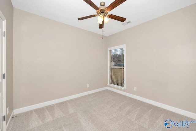 unfurnished room featuring light carpet, ceiling fan, visible vents, and baseboards