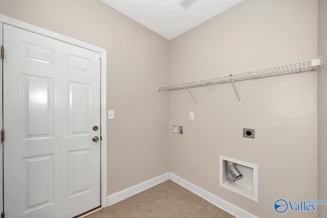 laundry area with light tile patterned floors, hookup for a washing machine, hookup for an electric dryer, laundry area, and baseboards