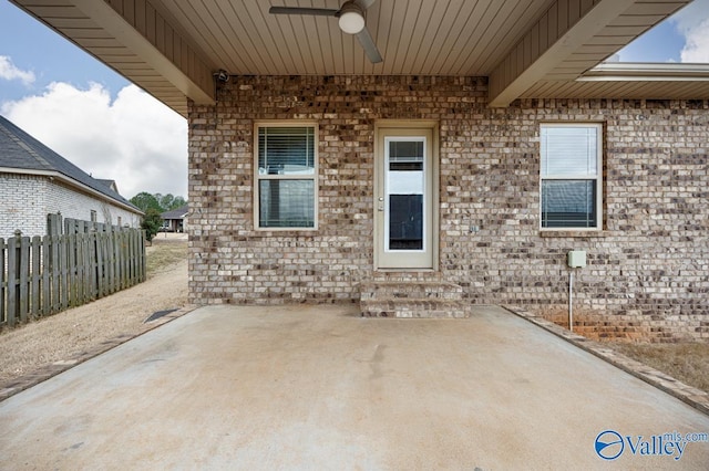 view of patio / terrace featuring entry steps, ceiling fan, and fence