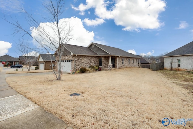 single story home featuring a garage, fence, concrete driveway, and brick siding