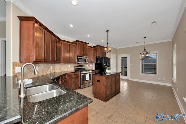 kitchen featuring light tile patterned floors, a sink, appliances with stainless steel finishes, backsplash, and a center island