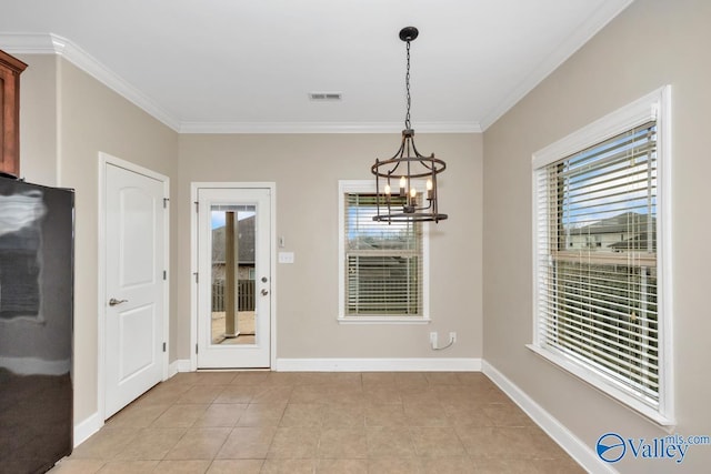 unfurnished dining area featuring baseboards, visible vents, and crown molding