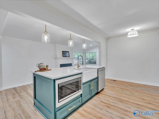 1901 Governors Dr SE, Huntsville, AL 35801 - kitchen featuring stainless steel appliances, light wood finished floors, ornamental molding, light countertops, and green cabinets