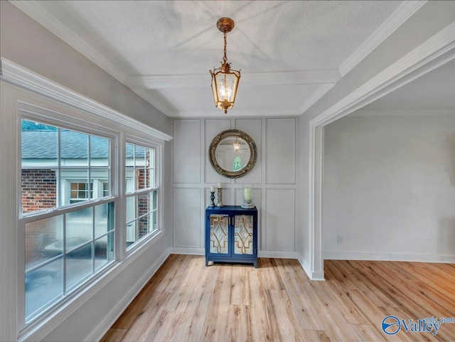 1901 Governors Dr SE, Huntsville, AL 35801 - entryway with a chandelier, a decorative wall, crown molding, light wood-style floors, and a textured ceiling