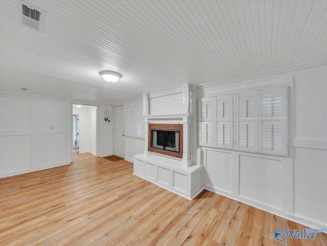 1901 Governors Dr SE, Huntsville, AL 35801 - unfurnished living room with light wood-type flooring, a decorative wall, a large fireplace, and wooden ceiling