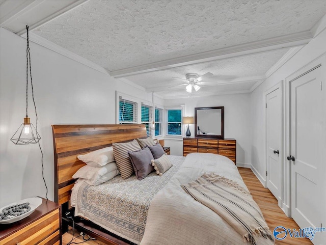 1901 Governors Dr SE, Huntsville, AL 35801 - bedroom with light wood-style flooring, beamed ceiling, crown molding, a textured ceiling, and a ceiling fan
