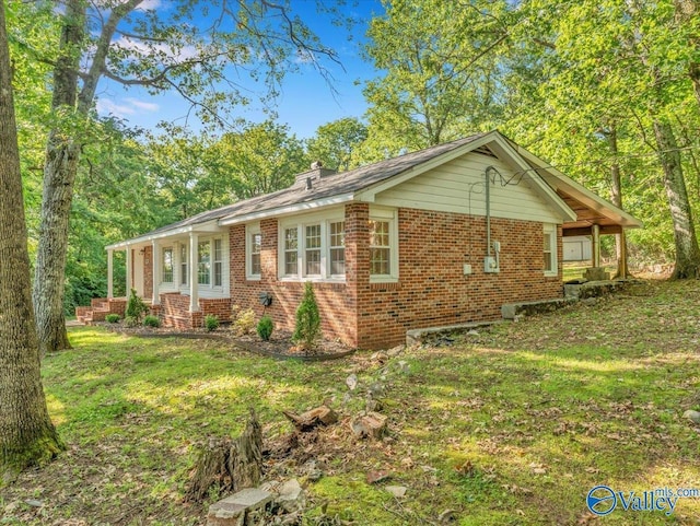 1901 Governors Dr SE, Huntsville, AL 35801 - view of front of house featuring brick siding, a front lawn, and a chimney